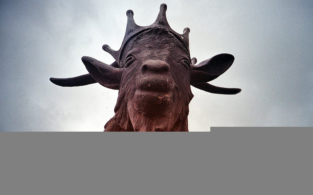 Statue of a goat with a crown